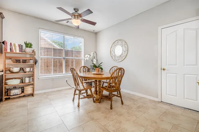 a dining room with furniture and a window