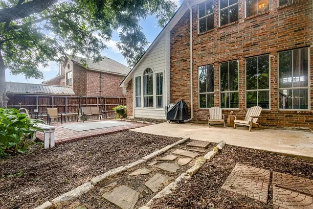 a view of a house with backyard sitting area and tub