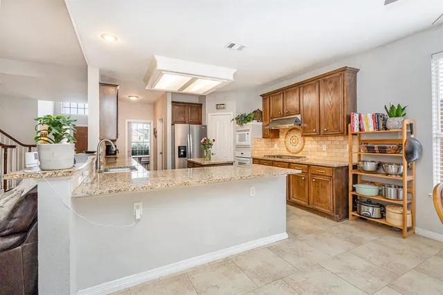 a kitchen with stainless steel appliances granite countertop a sink and cabinets