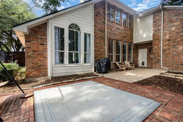 a view of a brick house with large windows