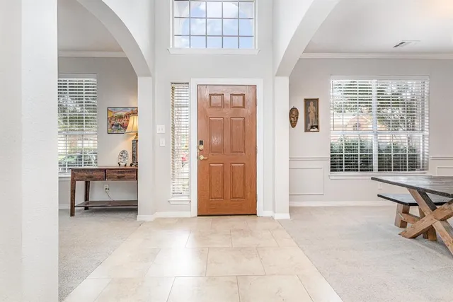 a view of a livingroom with a lounge chair and windows