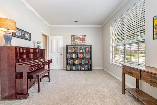 a living room with furniture and a piano