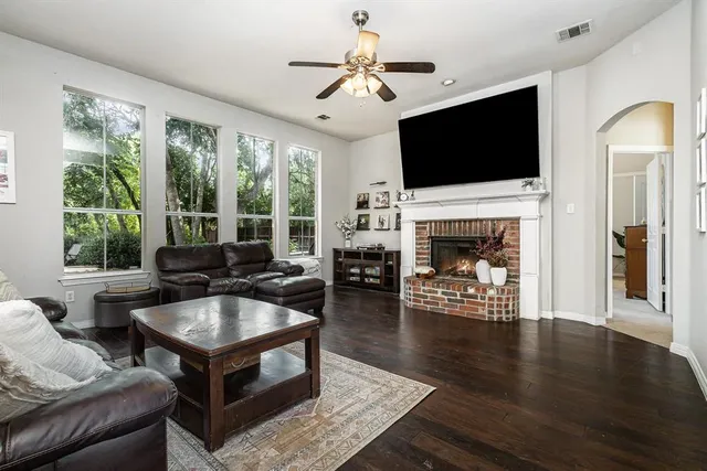 a living room with furniture a flat screen tv and a fireplace