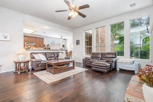 a living room with furniture fireplace and a large window