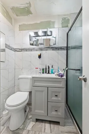 a bathroom with a toilet a sink and a shower