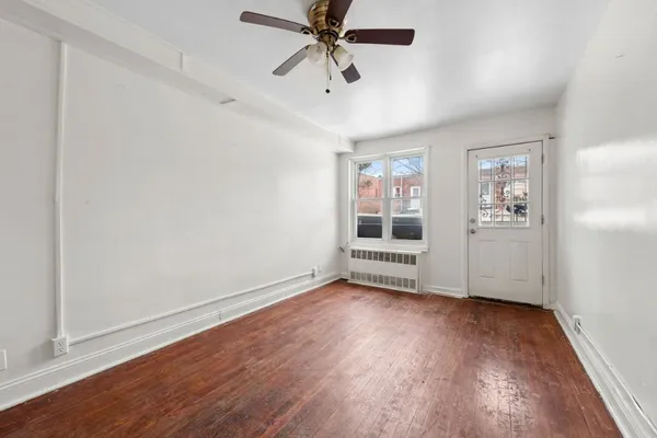 wooden floor in an empty room with a window