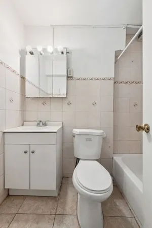 a bathroom with a sink a toilet and bathtub
