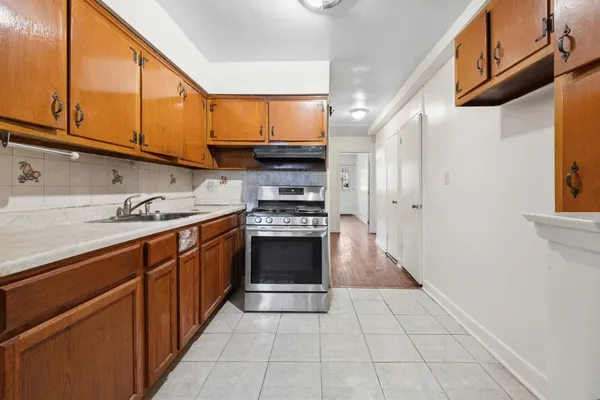 a kitchen with stainless steel appliances granite countertop a stove and a sink