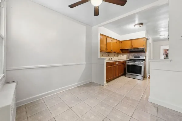 a kitchen with stainless steel appliances granite countertop a refrigerator and a stove