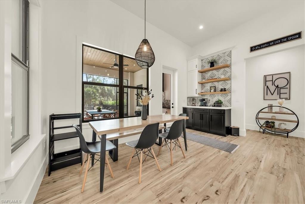 4186 3rd Avenue Northwest Naples, FL 34119 - Photo 11 of 50 a view of a dining room with furniture and wooden floor