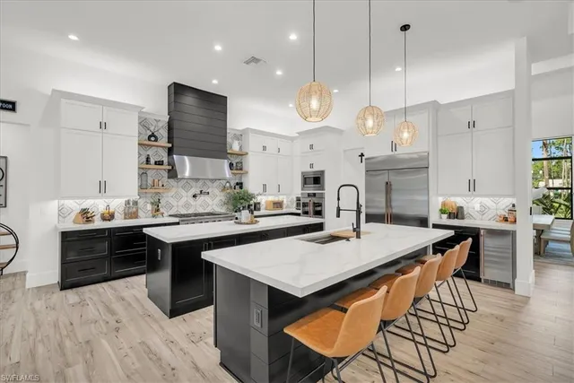 a large kitchen with a table and chairs in it