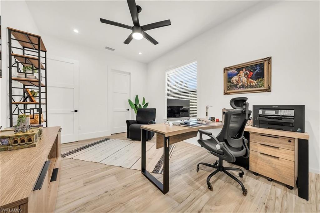4186 3rd Avenue Northwest Naples, FL 34119 - Photo 23 of 50 a view of a workspace with furniture and a potted plant