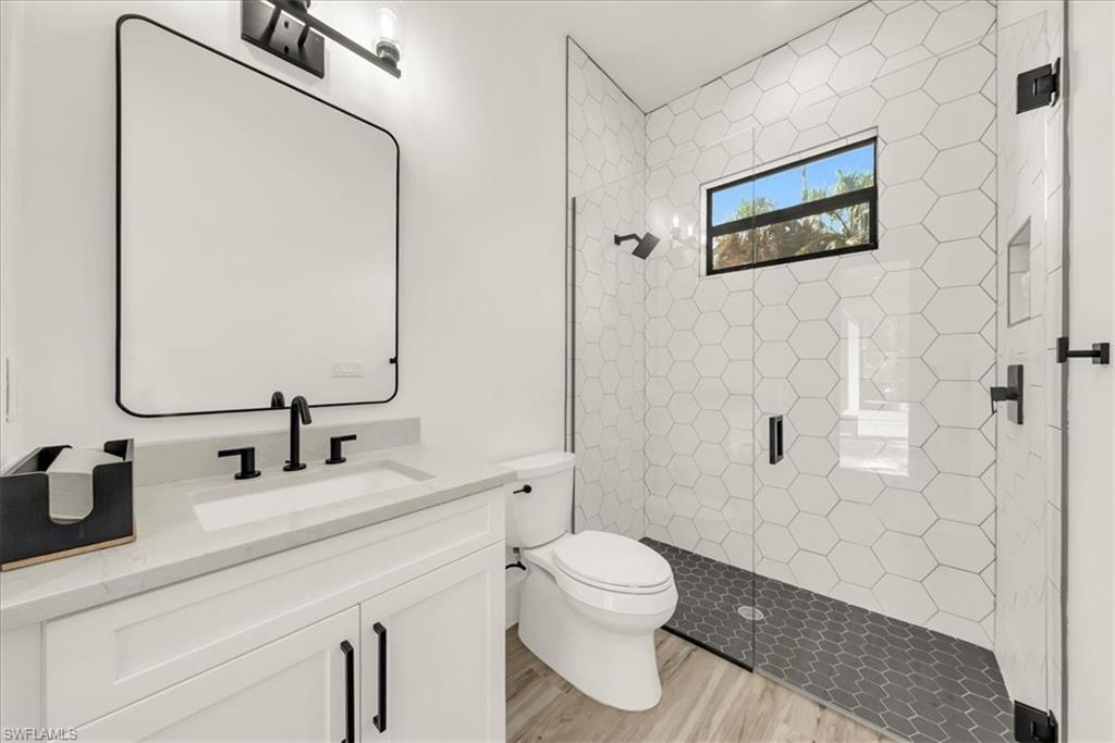 4186 3rd Avenue Northwest Naples, FL 34119 - Photo 26 of 50 a bathroom with a toilet sink and shower