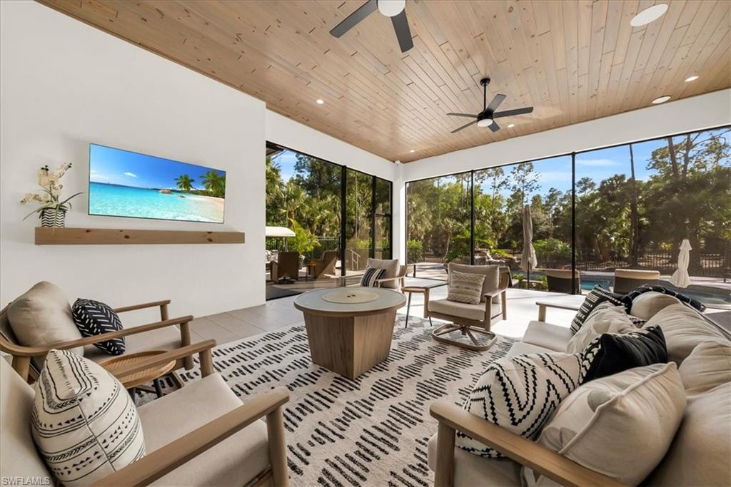 4186 3rd Avenue Northwest Naples, FL 34119 - Photo 33 of 50 a living room with furniture and a large window
