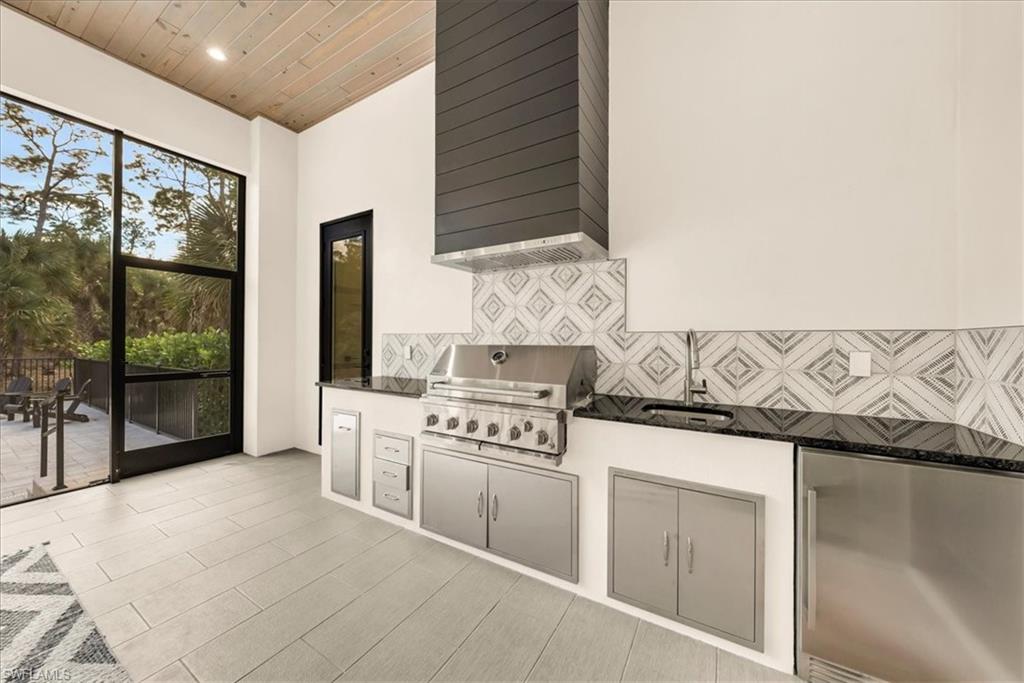 4186 3rd Avenue Northwest Naples, FL 34119 - Photo 36 of 50 a kitchen with stainless steel appliances granite countertop a stove and a sink