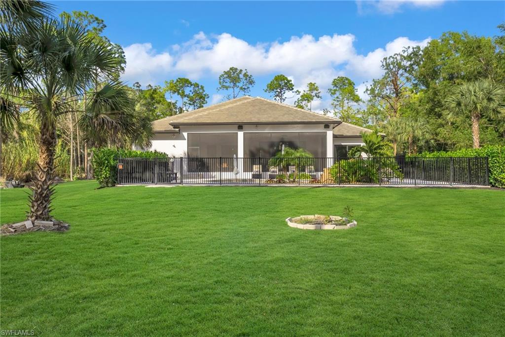 4186 3rd Avenue Northwest Naples, FL 34119 - Photo 38 of 50 a front view of a house with garden