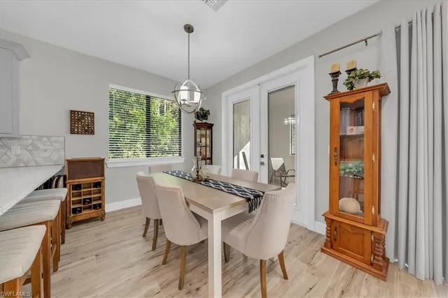 a bedroom with a large bed chandelier and a window