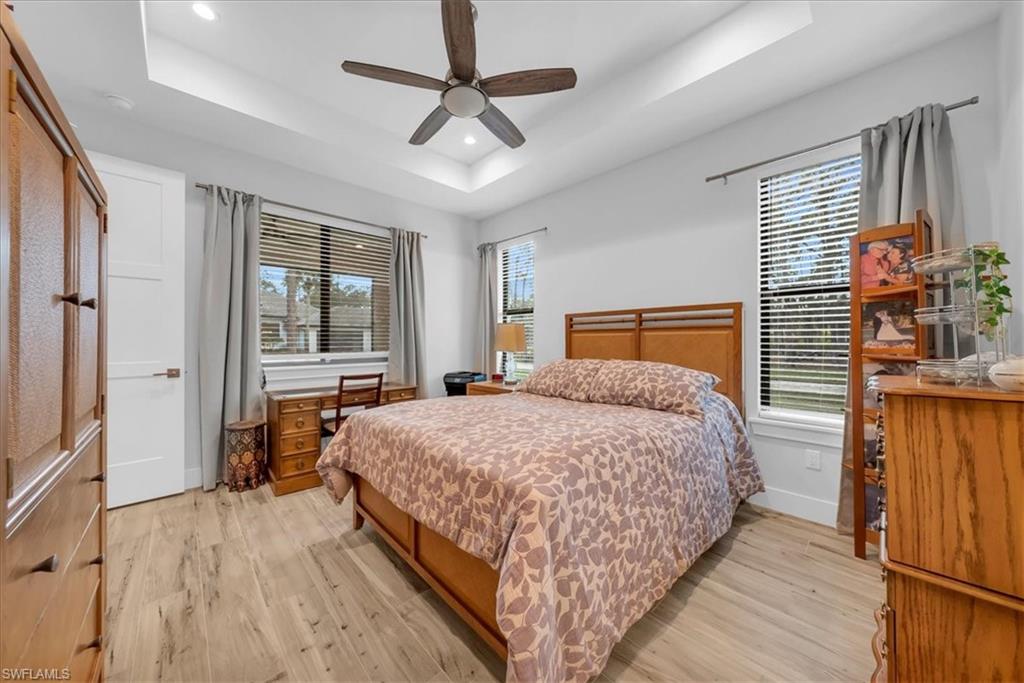 4186 3rd Avenue Northwest Naples, FL 34119 - Photo 45 of 50 a bedroom with a large bed chandelier and a window