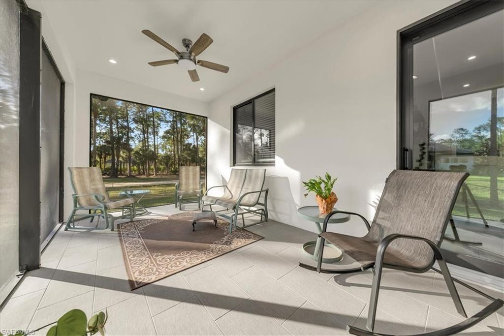 4186 3rd Avenue Northwest Naples, FL 34119 - Photo 49 of 50 a living room with patio furniture and a large window