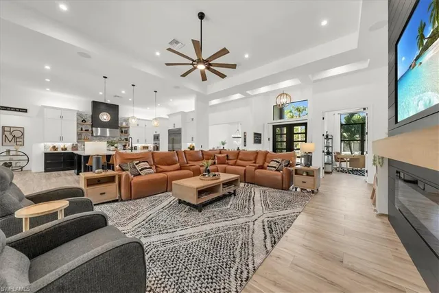 a living room with furniture kitchen view and a fireplace