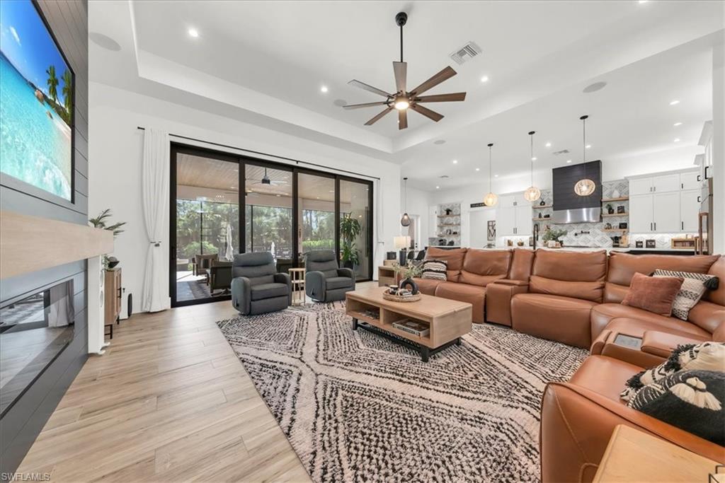 4186 3rd Avenue Northwest Naples, FL 34119 - Photo 9 of 50 a living room with furniture large window and a fireplace