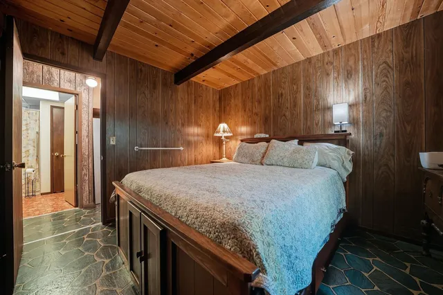 a kitchen with a sink a refrigerator and cabinets