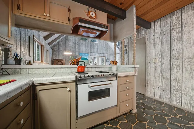 a living room with furniture a flat screen tv and large window