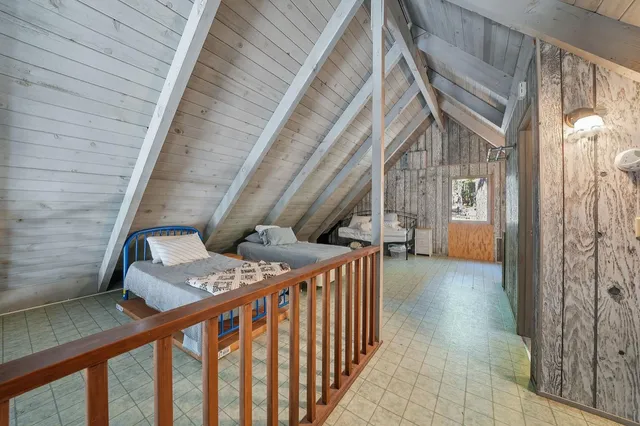 a view of balcony with chairs and wooden fence