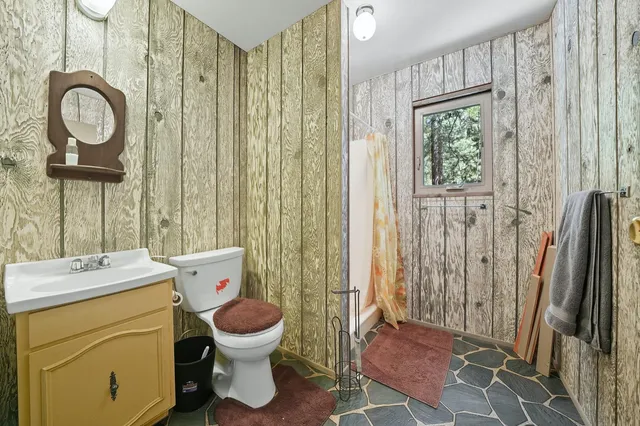 a backyard of a house with barbeque oven and outdoor seating