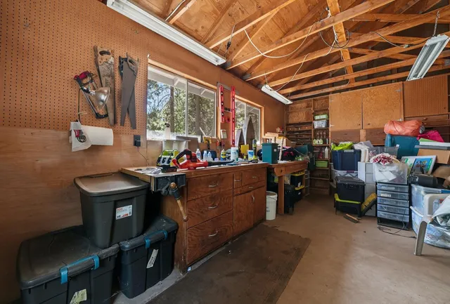 a view of a house with backyard and trees