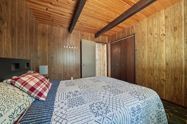 a bed room with a bed and a dresser