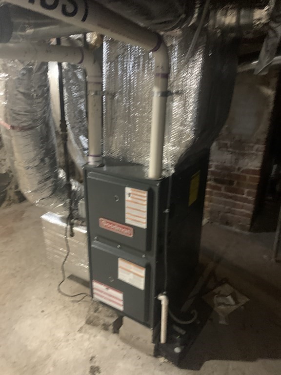 202-204 Lawrence Street Lawrence, MA 01841 - Photo 11 of 12 a room with water heater and wooden cabinets