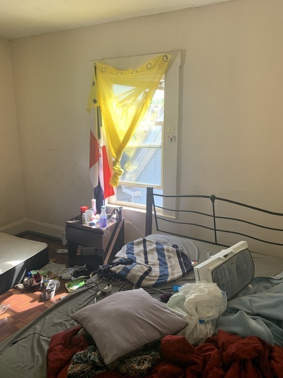 202-204 Lawrence Street Lawrence, MA 01841 - Photo 2 of 12 a living room with furniture and a window