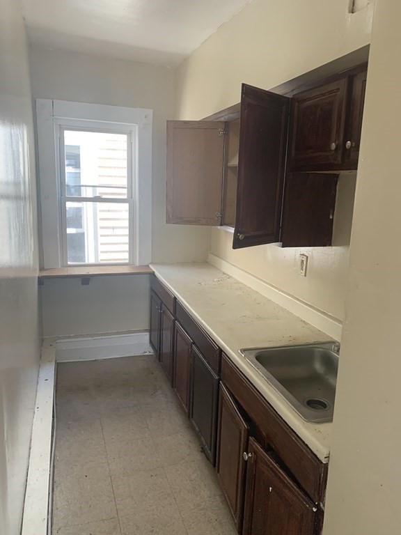 202-204 Lawrence Street Lawrence, MA 01841 - Photo 4 of 12 a kitchen with a sink and a stove top oven