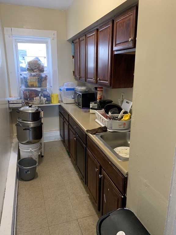 202-204 Lawrence Street Lawrence, MA 01841 - Photo 5 of 12 a kitchen with a sink appliances and cabinets