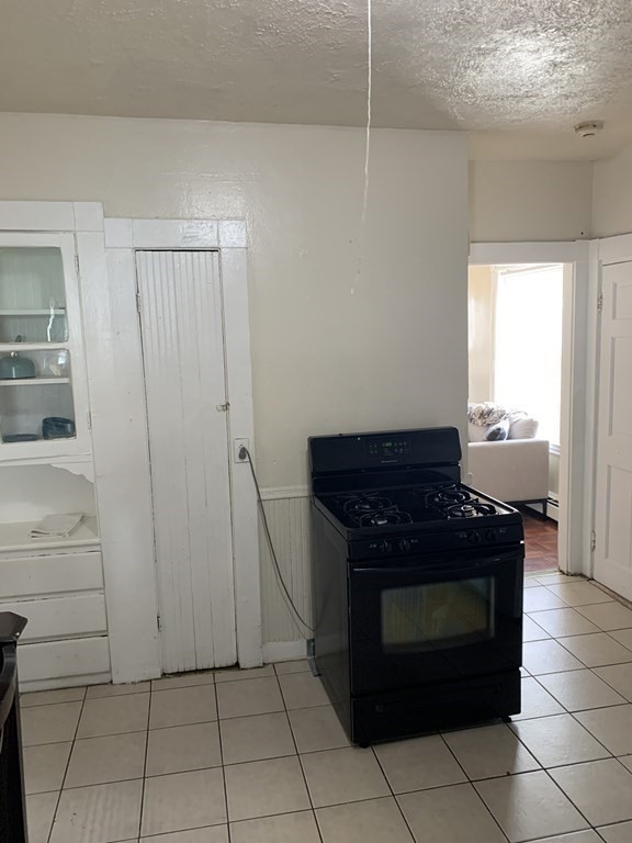 202-204 Lawrence Street Lawrence, MA 01841 - Photo 7 of 12 a kitchen with a stove