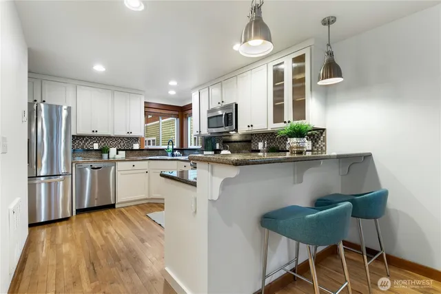 a kitchen with granite countertop lots of counter top space and stainless steel appliances