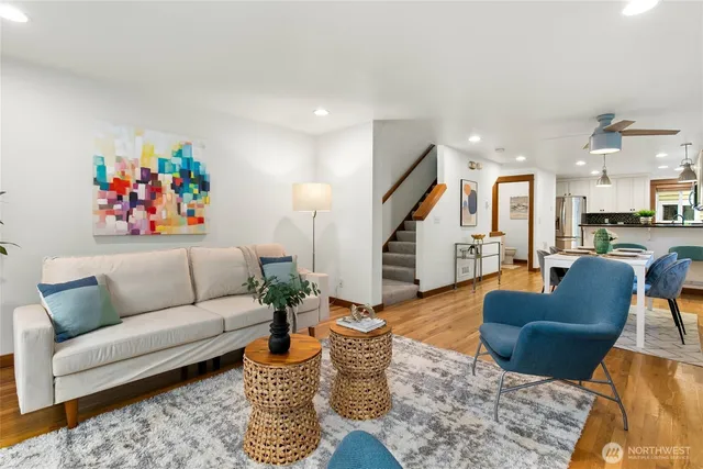 a living room with furniture and wooden floor
