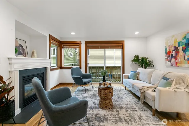 a living room with furniture fireplace and a large window