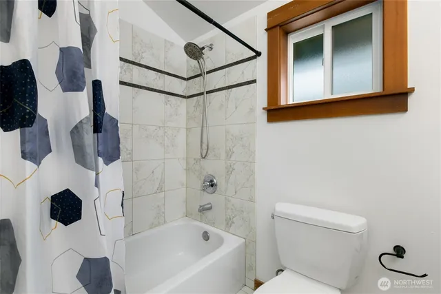 a bathroom with a bathtub and shower