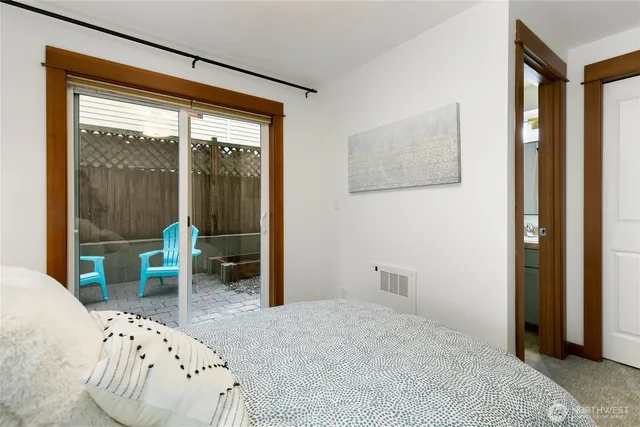 a bedroom with a bed and a large window