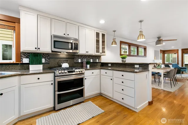 a kitchen with stainless steel appliances granite countertop a stove a sink and a granite counter tops