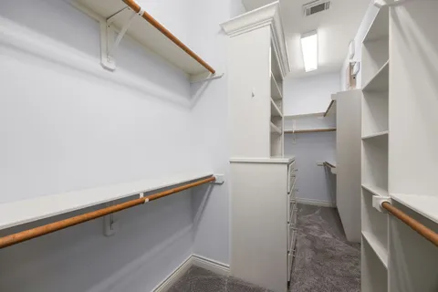 a bathroom with a granite countertop sink and a large mirror