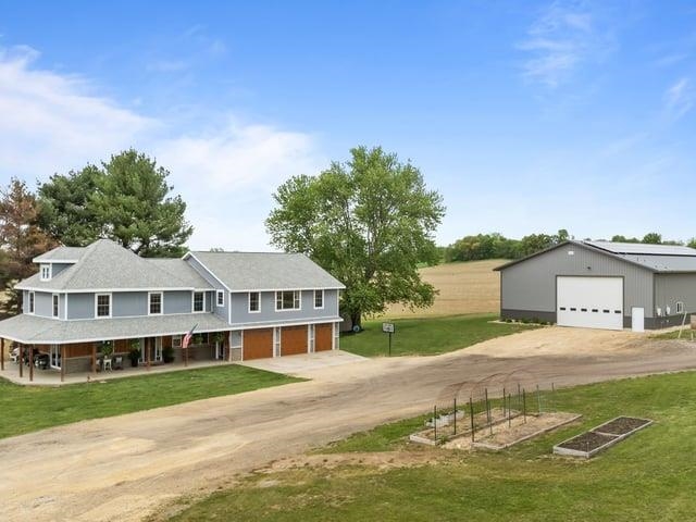 8294 North Leaf River Road Leaf River, IL 61047 - Photo 1 of 56 a house with a garden in front of it