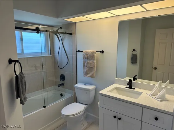 a bathroom with a sink toilet a shower and a mirror
