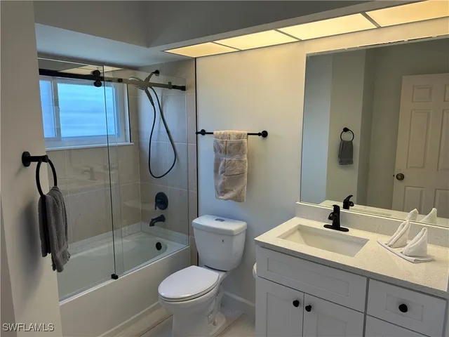 a bathroom with a sink toilet a shower and a mirror