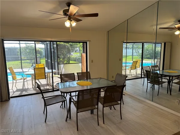a dining room with furniture window and wooden floor