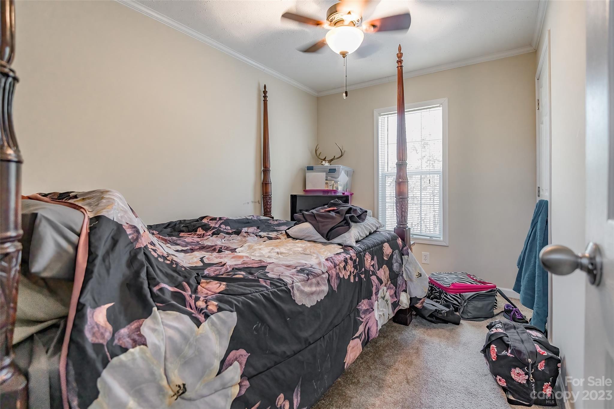 2168 Mission Road York, SC 29745 - Photo 12 of 19 a bedroom with a bed and a chandelier