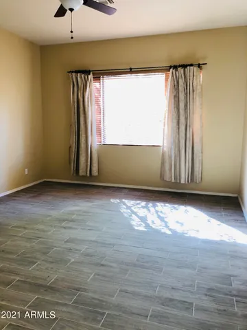 a view of a room with wooden floor and a window