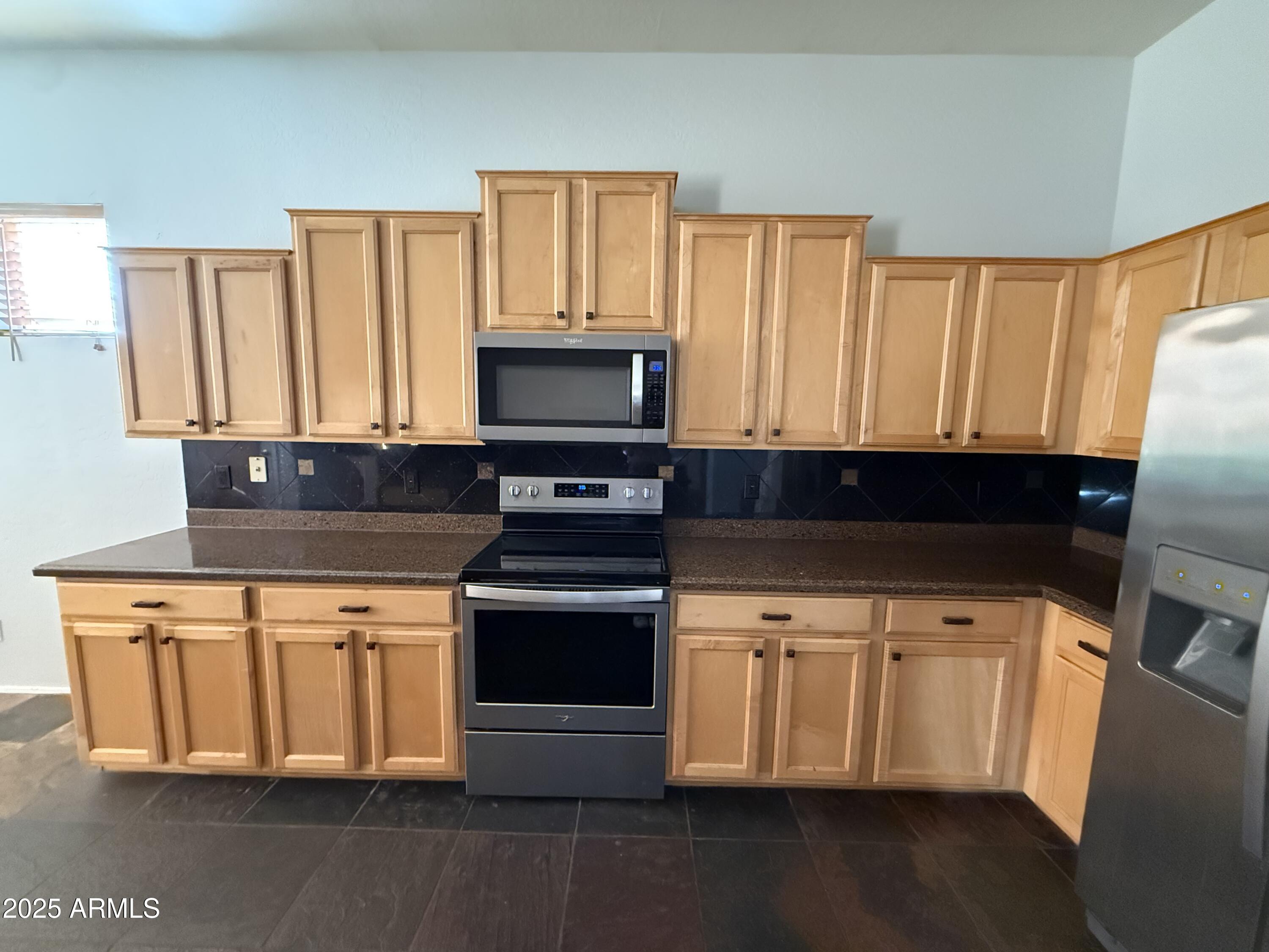 10453 East Pine Valley Drive Scottsdale, AZ 85255 - Photo 12 of 35 a kitchen with a stove and a microwave